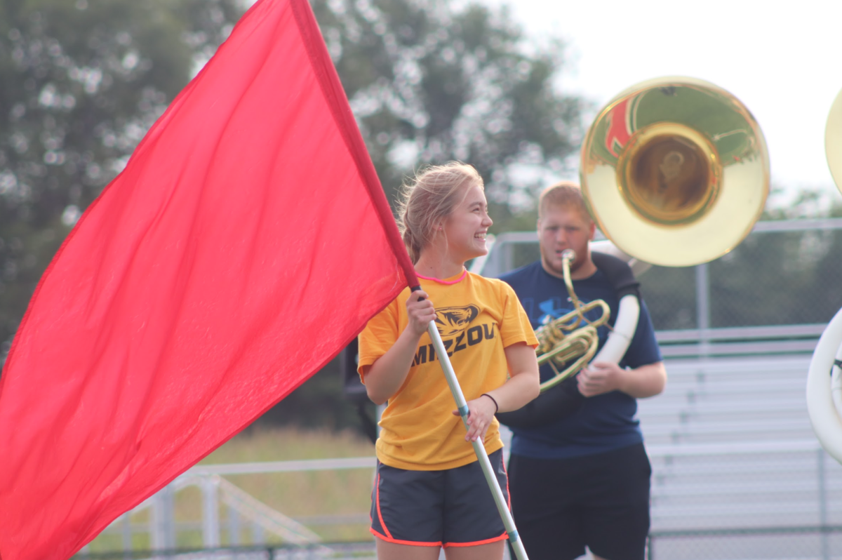 Color-Guard member Macy Czech (12) smiling while on the field.